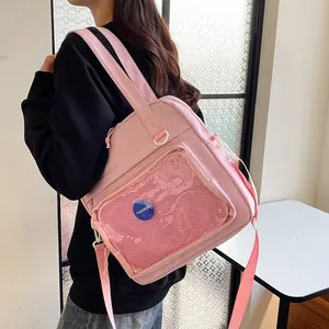 Detail view of the pink casual backpack featuring a transparent mesh front pocket