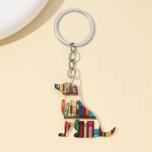 Decorative dog-shaped acrylic keychain featuring a colorful library book shelf design