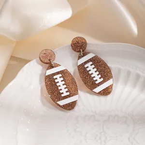 Stylish glittery brown American football stud earrings perfect for sports enthusiasts
