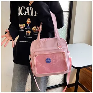 Large pink student handbag with a transparent front pocket and an adjustable strap