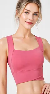 Close-up of pink sports bra showing wide shoulder straps and supportive side wings