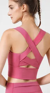 Macro view showing the functional cross-strap back design of a pink yoga sports bra
