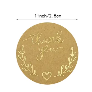 Detail view of 1-inch kraft paper thank you sticker with gold foil olive branch