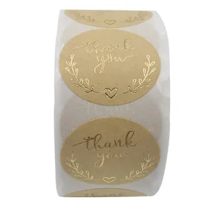 Detail of kraft paper thank you stickers with gold foil olive branch and heart design
