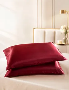 Detailed macro shot of wine red faux silk satin pillowcases with a smooth finish