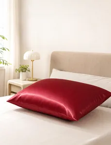 Luxurious wine red satin pillowcase with smooth silk-like texture on a cozy bedroom bed