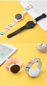 Detailed view of LED sports watches with vibrant rainbow silicone straps on yellow background.