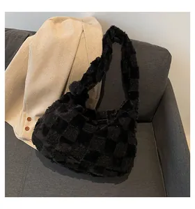 Close-up showing the soft plush texture and checkerboard pattern of the black tote bag