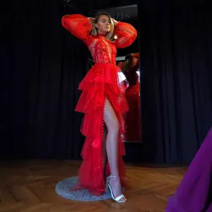 Vibrant red mesh long sleeve prom dress with layered ruffles and high slit detail.
