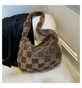 Detail view of a soft brown checkered plush tote bag resting on a white vintage chair