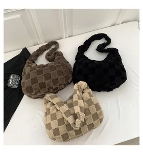 A detailed view showing three plush checkered tote bags in brown, black, and beige