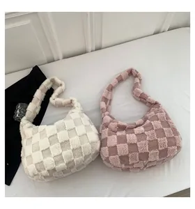 Detail view of large capacity plush checkerboard shoulder bags in cream and pink colors.