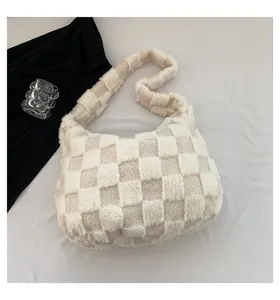Detailed view of a soft plush checkered hobo bag with thick strap and fluffy winter texture