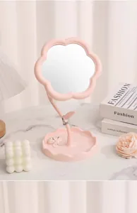 Close-up of pink flower shaped desktop vanity mirror with jewelry tray base