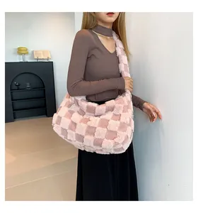 Close-up detail of a soft pink and white checkered plush tote bag worn by a model in a room