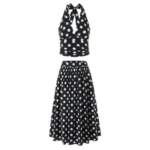 Zweiteiliges Set aus Retro-Oberteil mit Neckholder und gepunktetem Midirock in Schwarz.