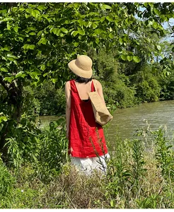 Vintage fine raffia straw sun hat for women displayed in a natural outdoor scene