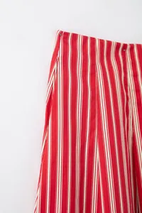 Détail du tissu et de la taille d'une jupe midi à rayures verticales rouges et blanches