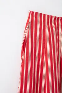 Détail rapproché d'une jupe midi à rayures rouges et blanches montrant la taille et la poche