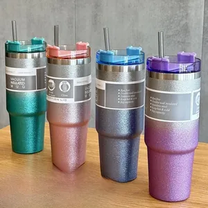 Detailed view of four glitter-finish 20oz/30oz stainless steel tumblers with lids and straws