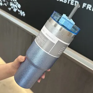Detail view of a blue glitter finish 20oz vacuum insulated stainless steel tumbler with straw.