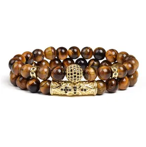Nahaufnahme von zwei 8mm Tigerauge-Perlenarmbändern mit goldenen Mikro-Pave-Kronen-Elementen