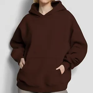 Detail view of oversized solid chocolate brown long sleeve hoodie with front pocket