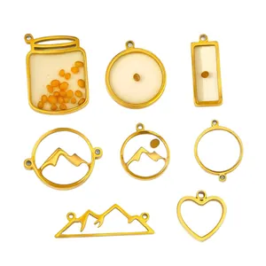 Collection of gold-plated stainless steel charms featuring mustard seeds and mountain silhouettes