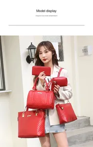 Model showcasing a premium 6-piece red quilted leather handbag set for women.