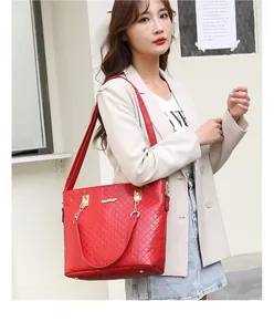 Elegant red quilted tote bag shown in a professional lifestyle street style shot with model