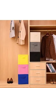 Foldable non-woven fabric storage boxes stacked in a wooden closet for home organization.