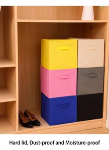 Macro view of colorful foldable fabric storage cubes inside a wooden wardrobe.