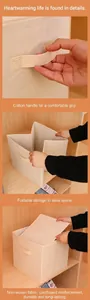 Detail view of a foldable non-woven storage box with a soft cotton handle and space-saving design.