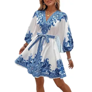 Elegant white summer dress with blue paisley print, puff sleeves and adjustable waist tie.