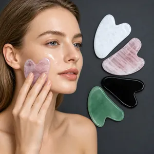 Detailed view of different natural stone heart-shaped gua sha massage tools