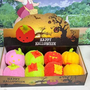 Colorful Halloween LED pumpkin squeeze toys with puffer texture in thematic display box.