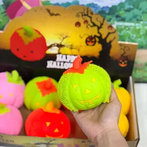 Close-up of vibrant lime green Halloween pumpkin puffer squeeze toy held in hand for scale