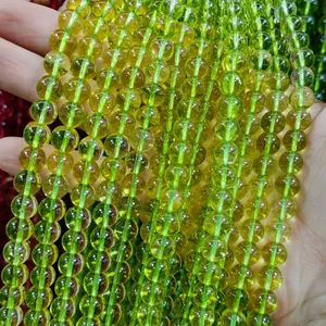 Detailed macro view of translucent lime green phantom crystal glass beads for DIY jewelry making.