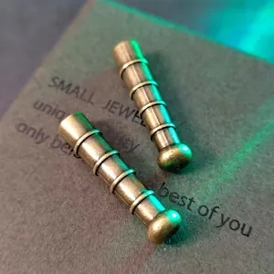 Primer plano de terminales de cordón en bronce antiguo con ranuras decorativas para DIY