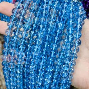 Close-up of vibrant blue transparent glass round beads for DIY jewelry making.