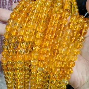 Macro view of high-quality transparent yellow crystal glass round beads for DIY jewelry making