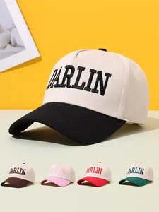 Close-up of DARLIN embroidered baseball caps showing multiple color variants in a studio setting