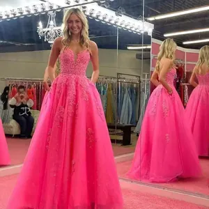 Detailed view of hot pink lace ball gown with delicate floral embroidery and tulle skirt