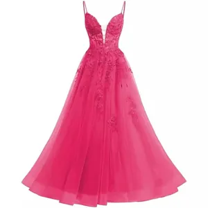 Macro view of detailed lace embroidery and layers of pink tulle on a formal prom gown