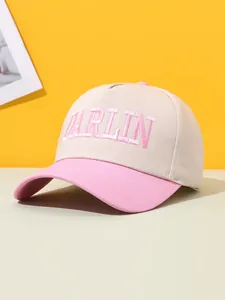 Detail shot of the DARLIN pink embroidery on this stylish two-tone beige baseball cap