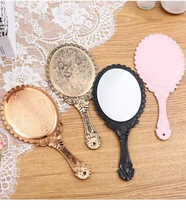 Elegant collection of vintage handheld mirrors in rose gold, gold, black, and pink colors.