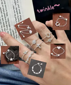 Macro view of adjustable S925 sterling silver chain rings with heart and star charms.