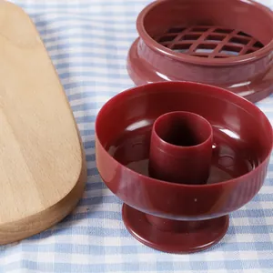 Red plastic donut mold for DIY baking, featuring a hollow cutter and grid accessory.