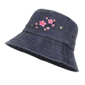 Close-up of cherry blossom embroidery on washed grey denim bucket hat for sun protection.