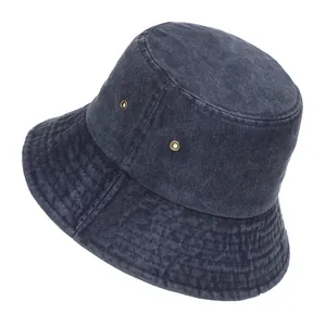 Detailed side view of a dark navy washed denim bucket hat with metallic eyelets.
